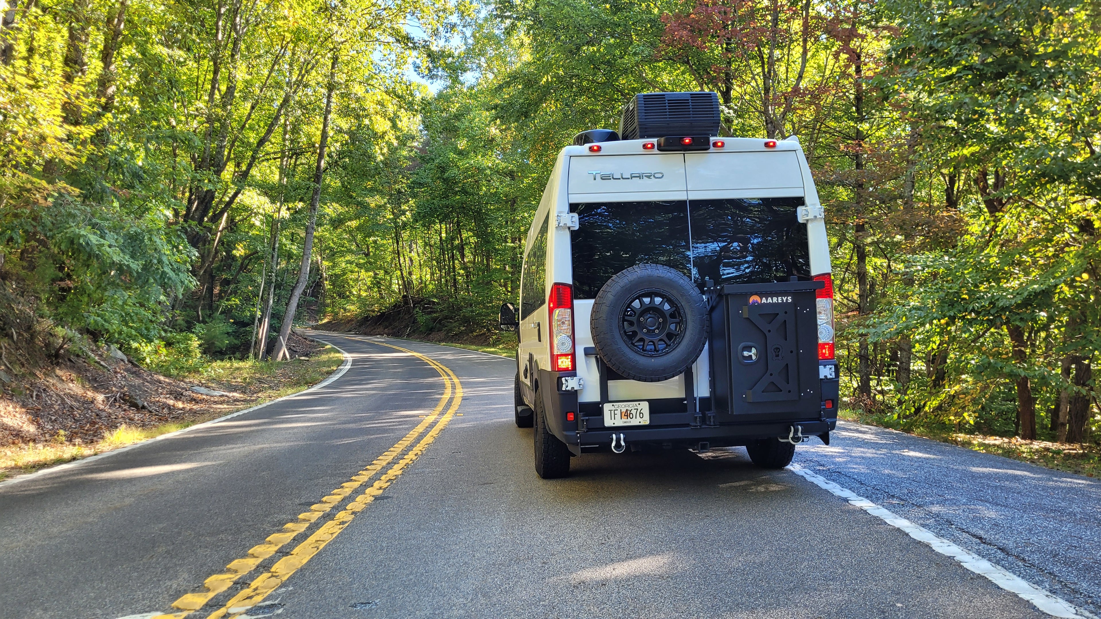 Van on road equipped with aareys swing arm bumper