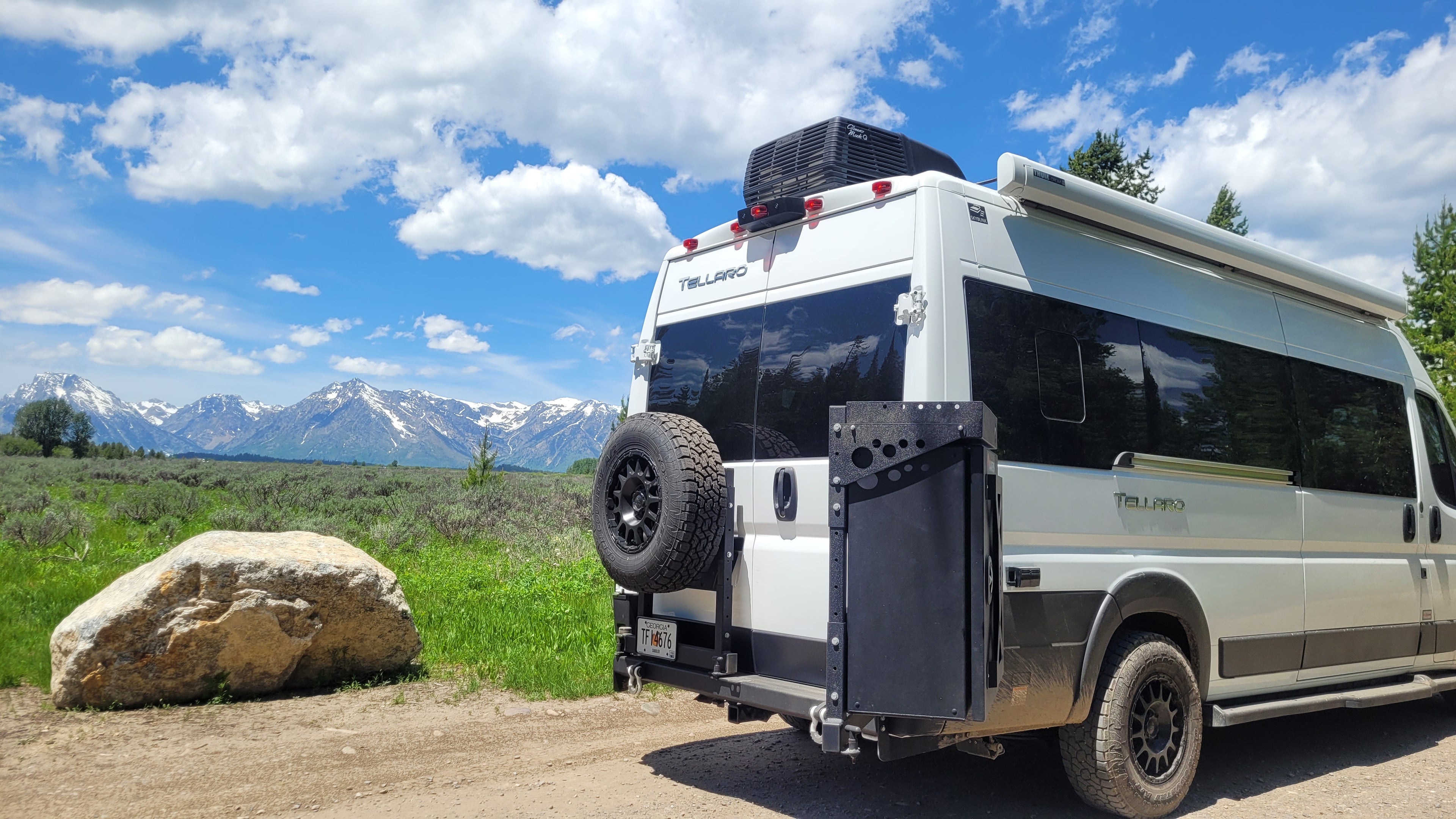 Van equipped with aareys swing arm bumper infront of mountains
